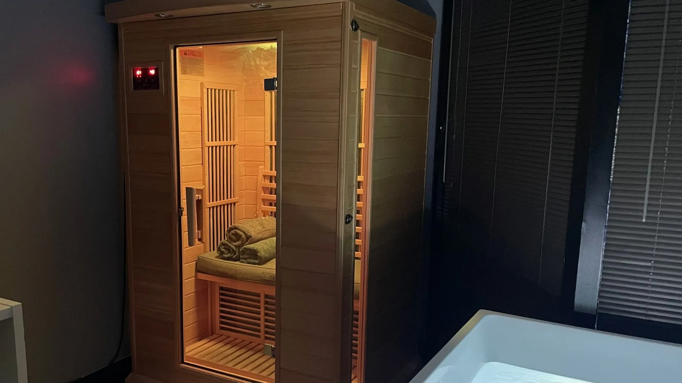 The recovery room at Iron Ambition: a cedar infrared sauna lit from within, beside the cold plunge